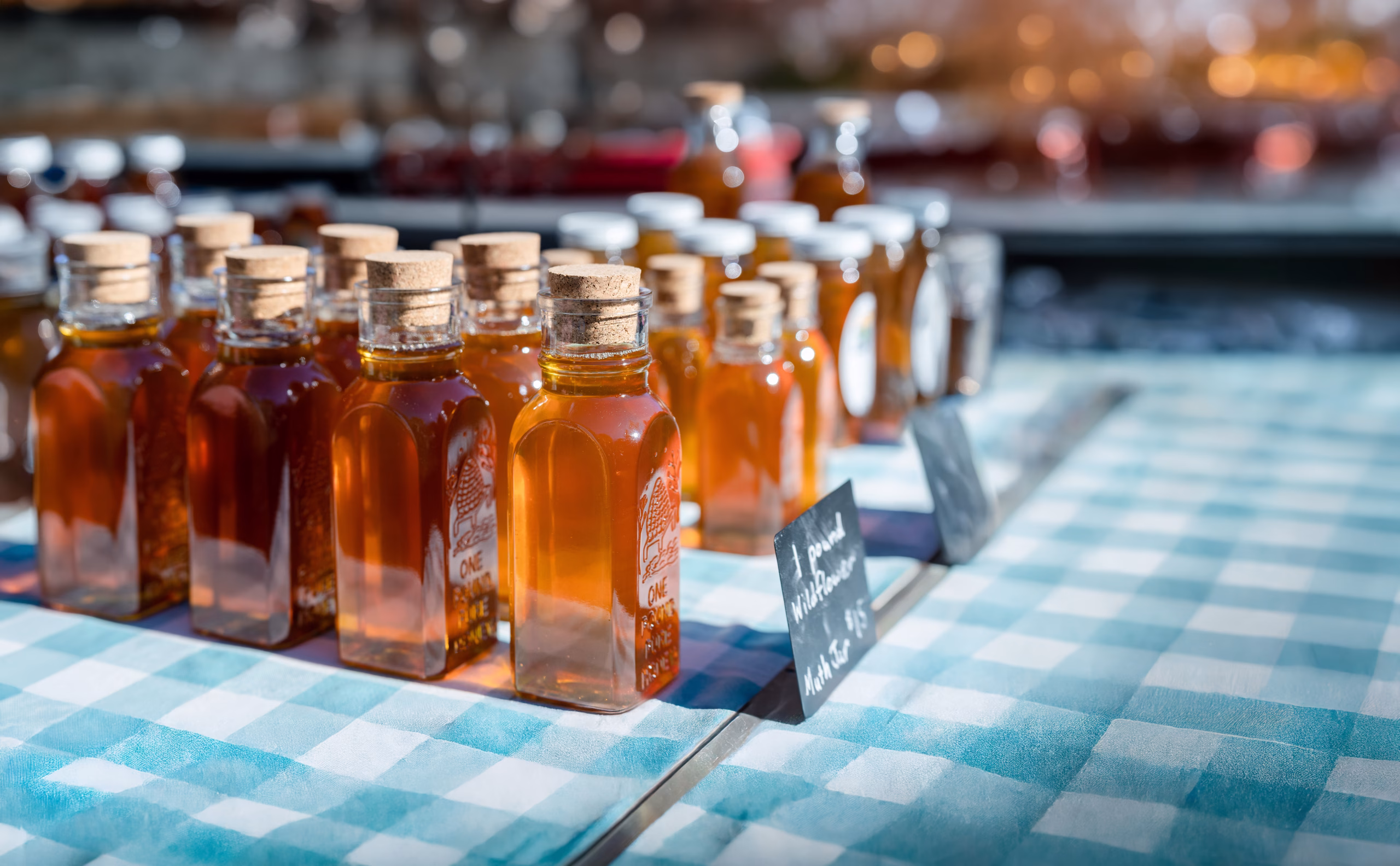 honey bottles with corks at a local farmers market